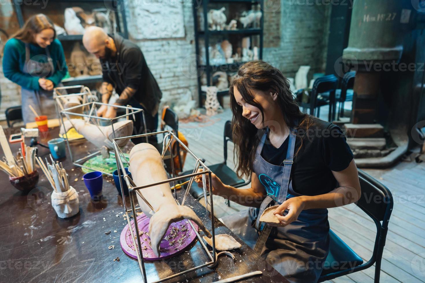 Portrait of young woman enjoying favorite job in workshop. photo