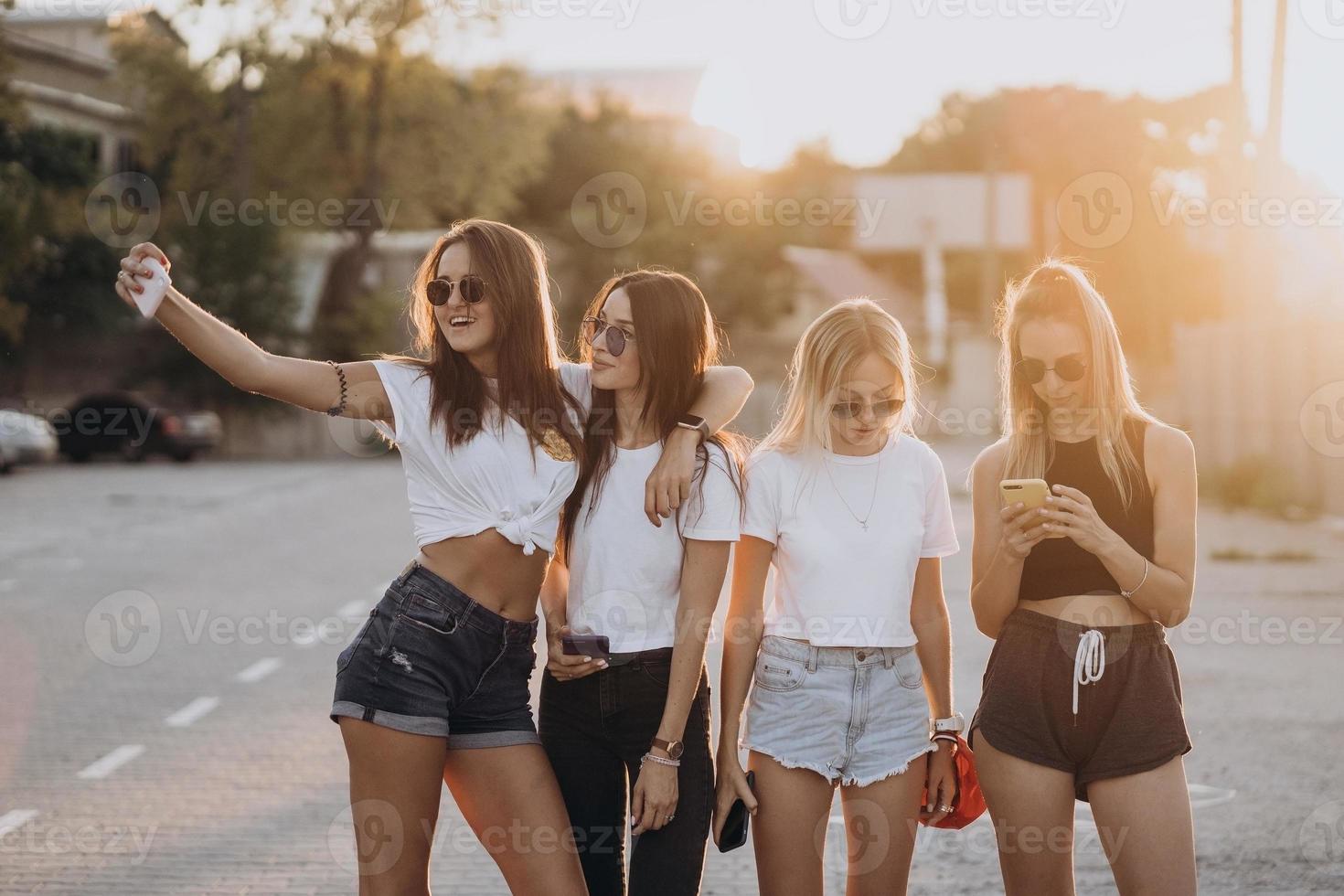 Four young women taking a selfie and have fun photo