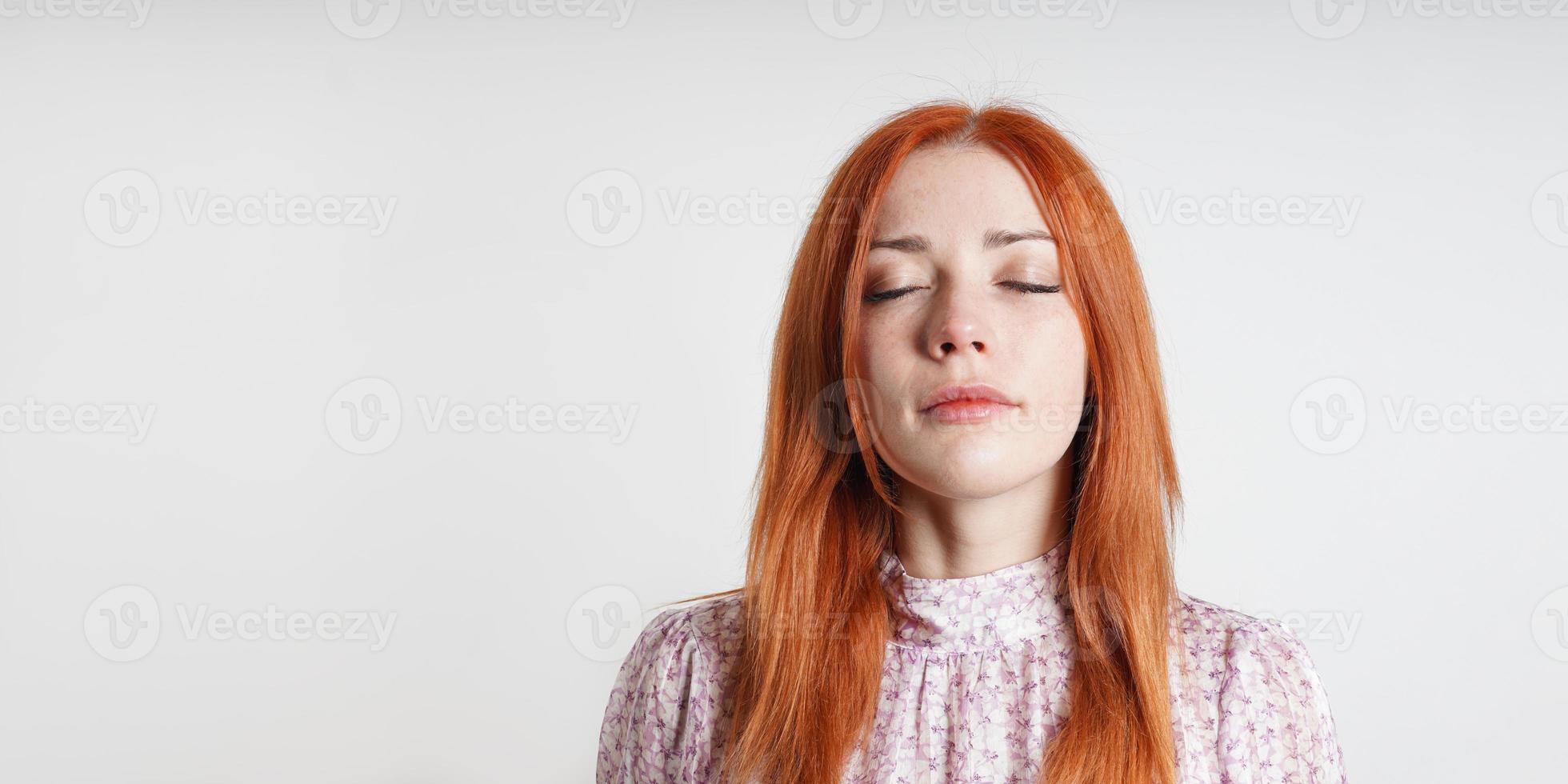 Calm peaceful woman meditates with closed eyes - introspection mindfulness and self-care photo
