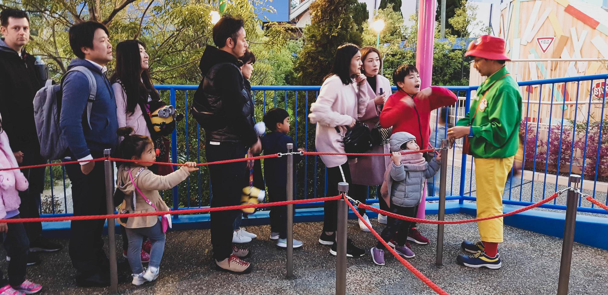 Osaka, Japan in April 2019. Children and several adults are queuing to enter a ride at Universal Studios Japan. photo