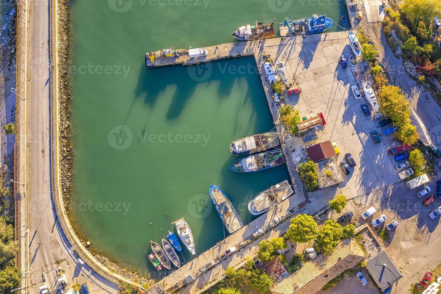 Aerial top view from drone to the seacoast and small marina with boats and yachts. Sea landscape with yachts from above photo