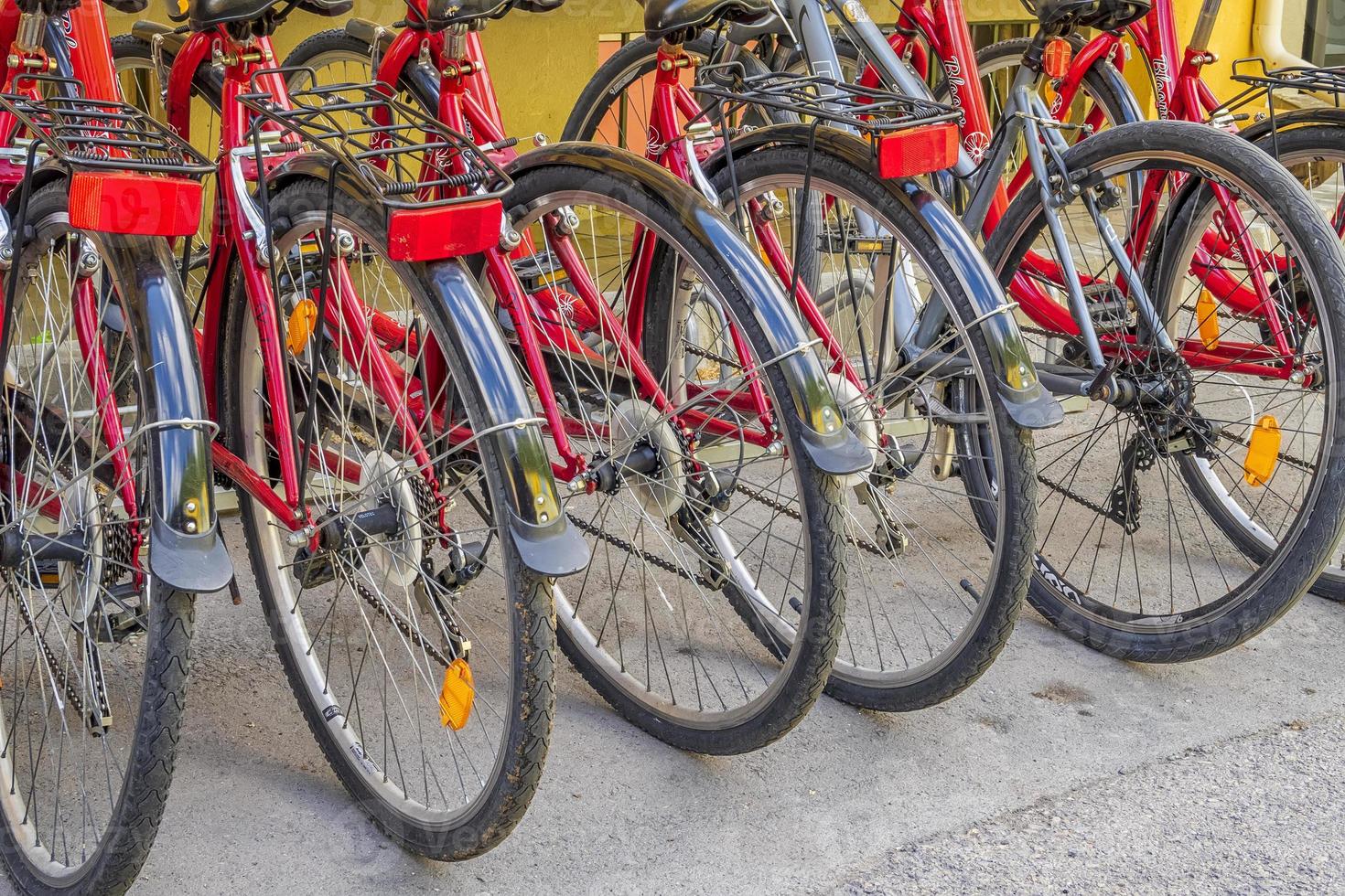 Bicycle parking station full of bikes. Many parked bicycles. Close up photo