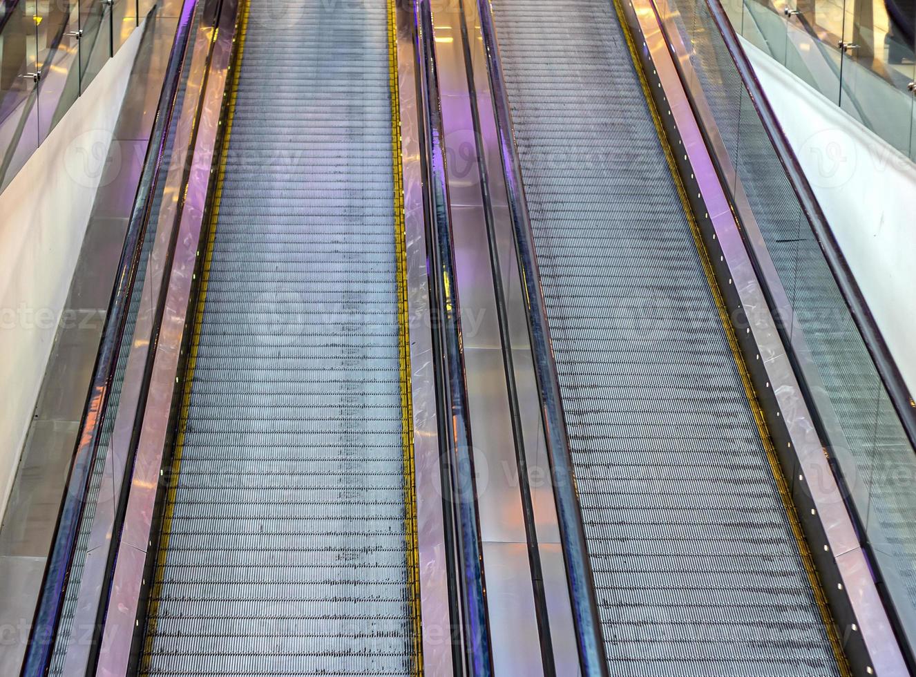 Lifting escalator. The descent into the subway, mall, underpass, moving stairs photo