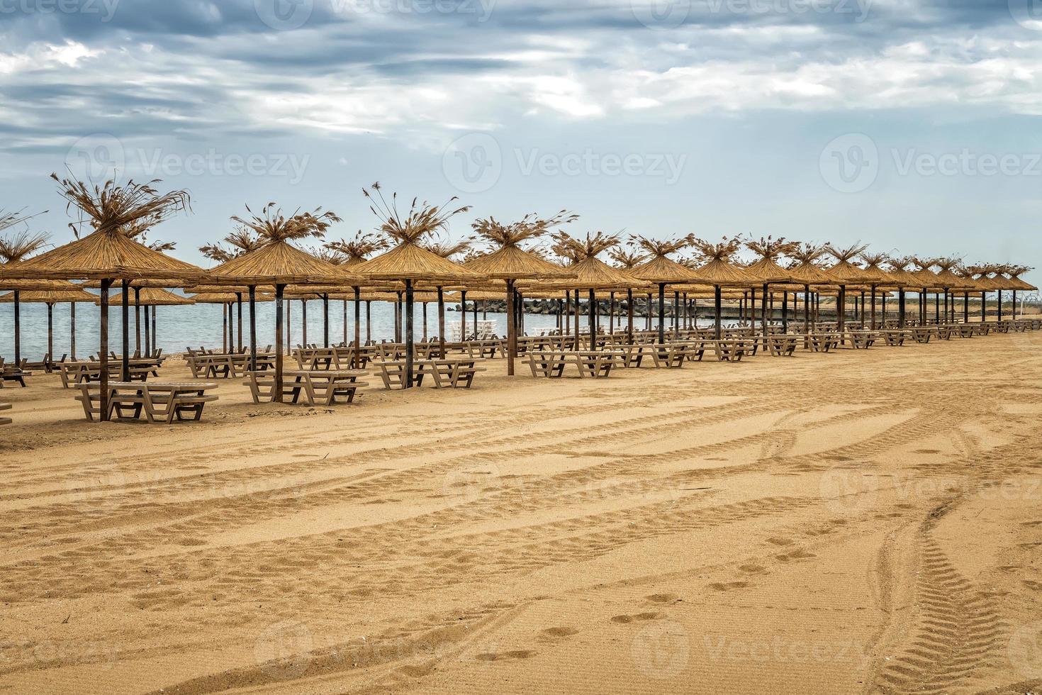 Empty sandy beach and rows resting places in the failed tourist season. photo
