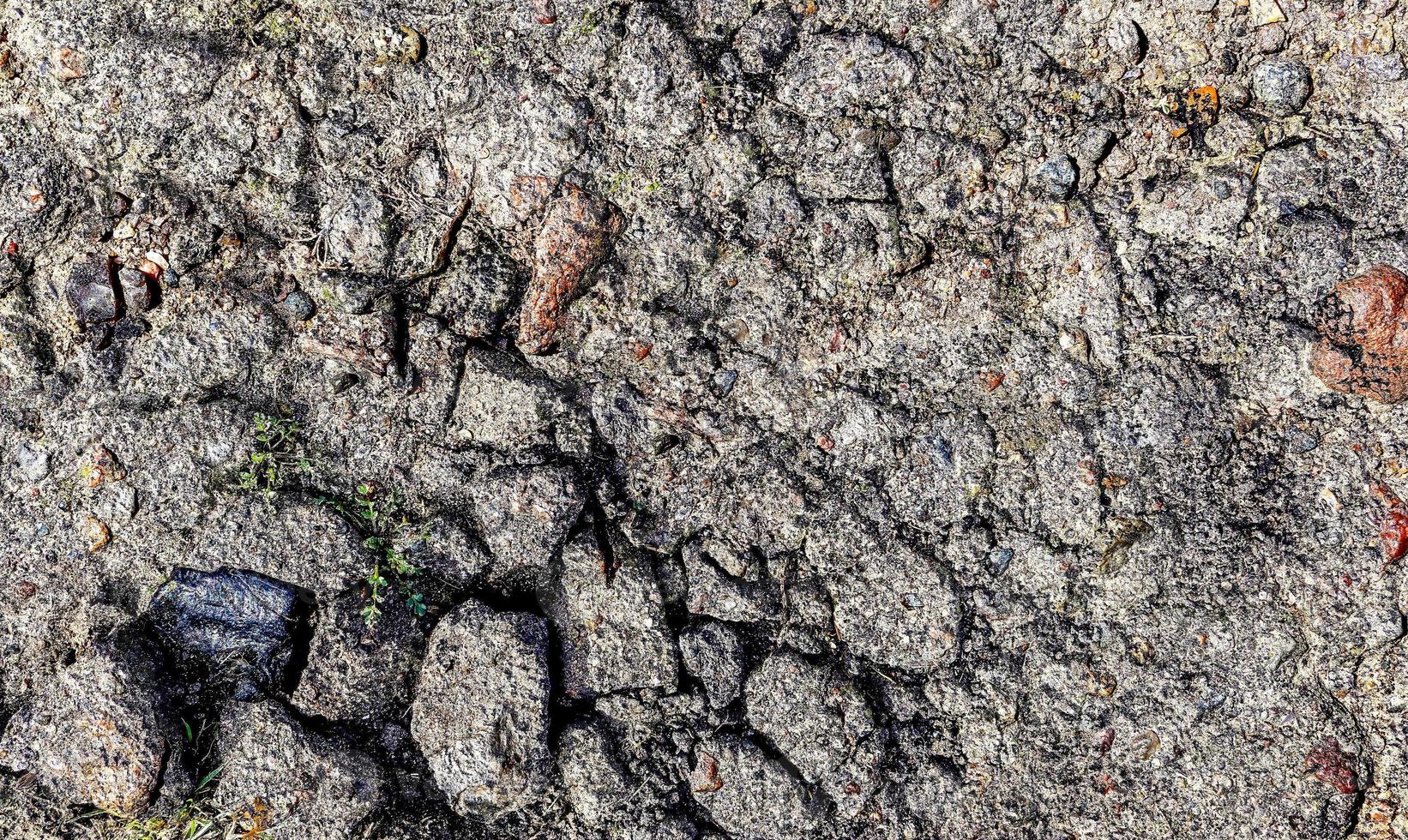 Detailed view on asphalt surfaces of different streets and roads with cracks photo