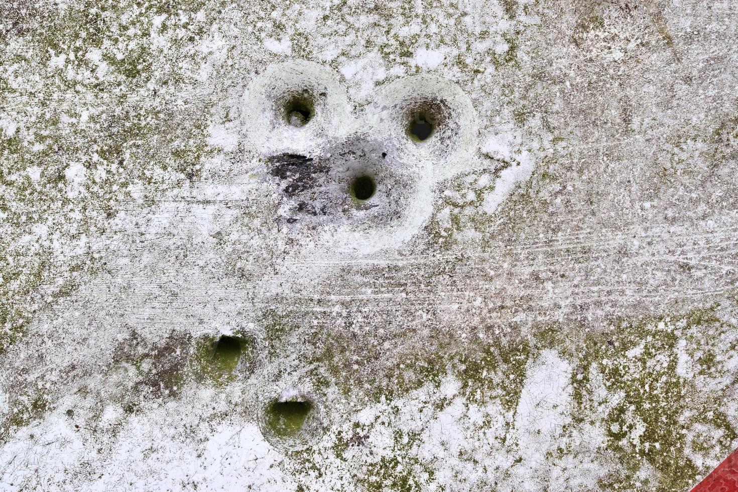 Detailed close up of bullet holes from gun shots in a traffic sign photo