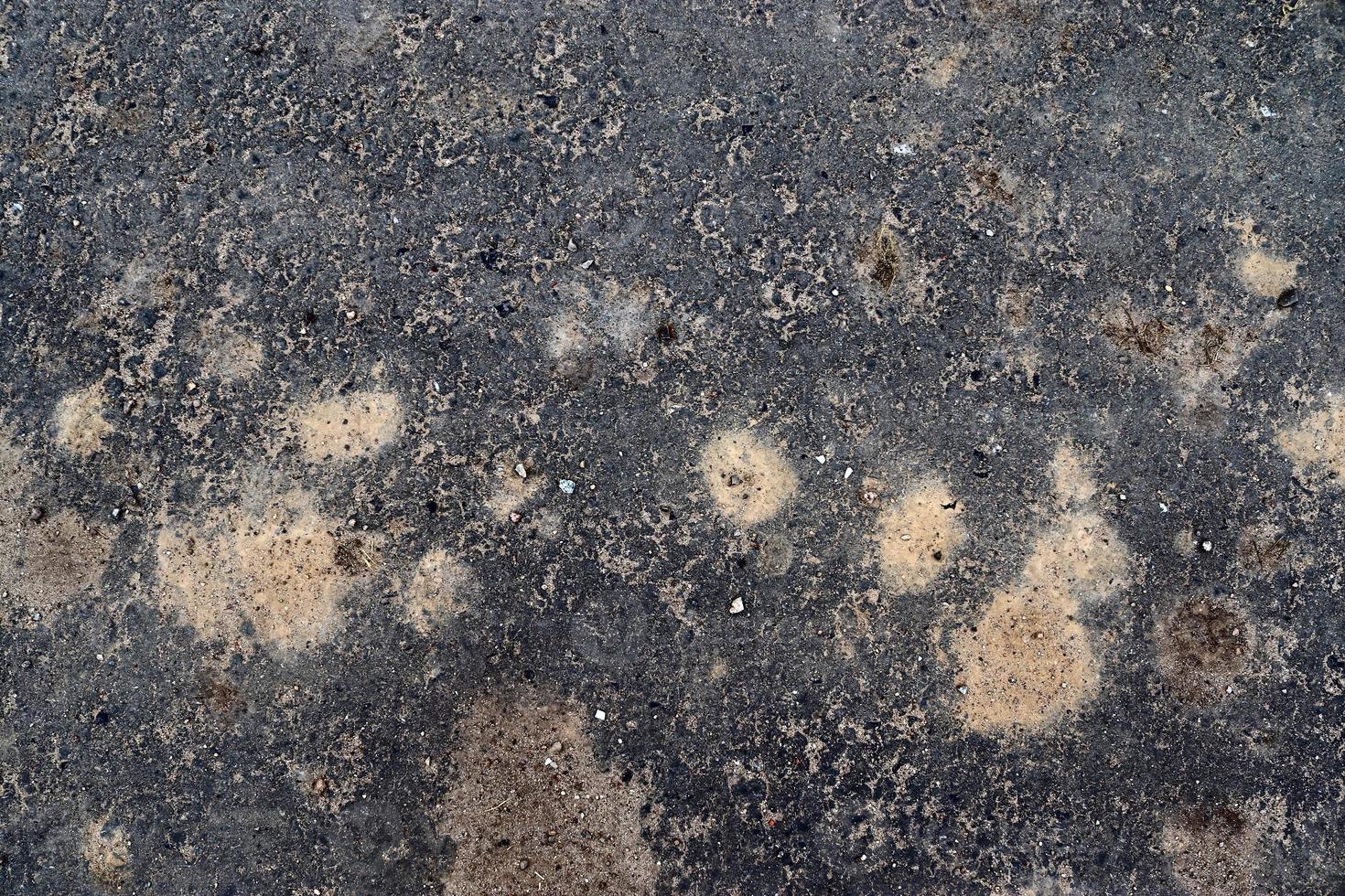 Detailed view on asphalt surfaces of different streets and roads with cracks photo