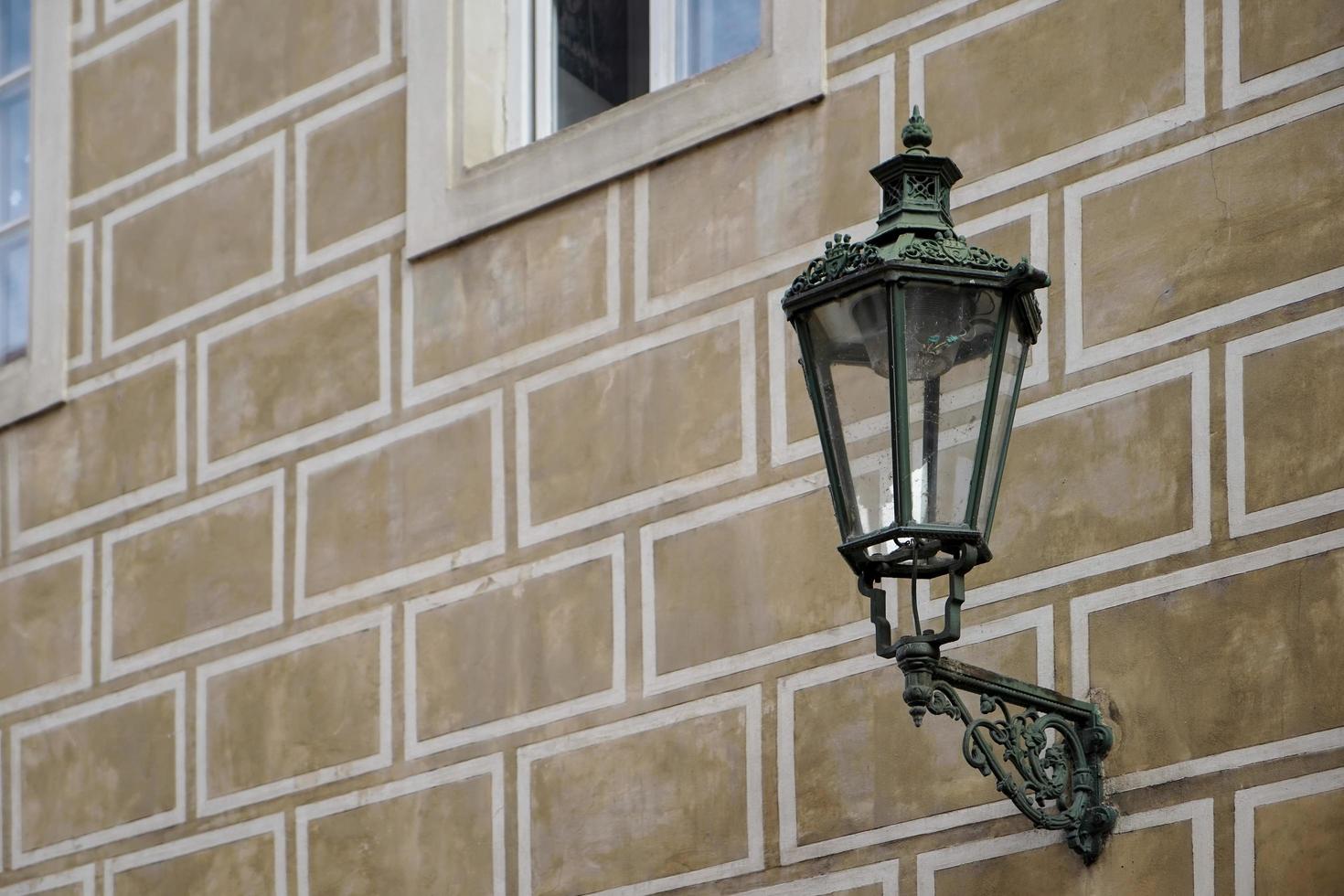 Prague, Czech Republic, 2014. Old fashioned street lamp on a building in Prague photo