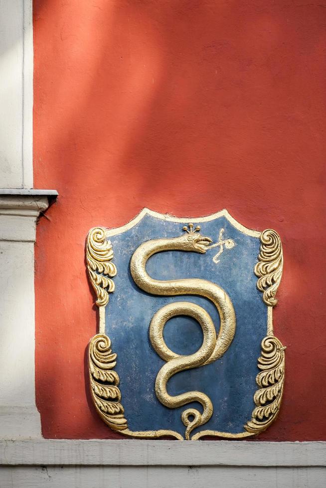 Prague, Czech Republic, 2014. Sign of the Golden Snake on the U Zlateho hada cafe in Prague photo