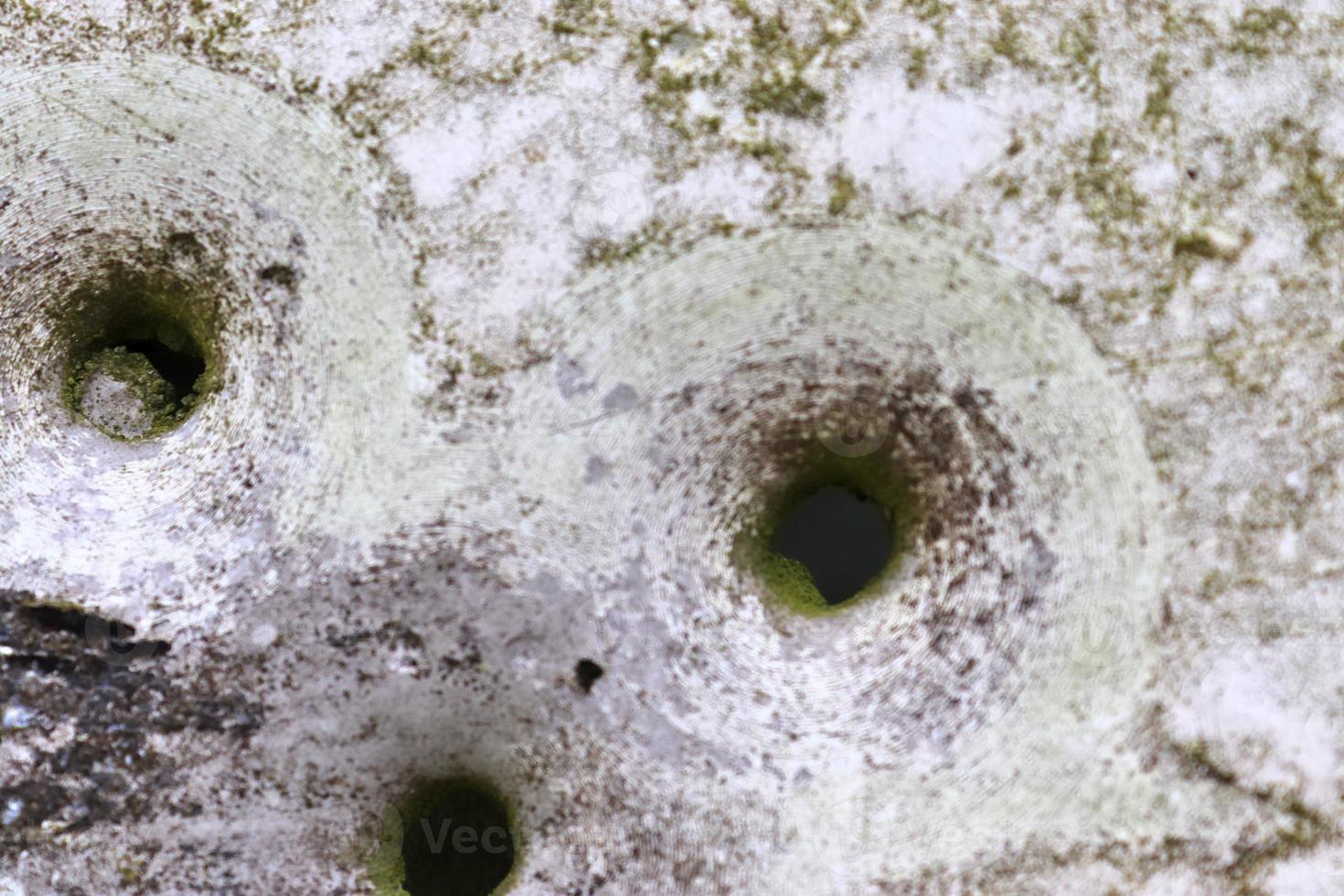 Detailed close up of bullet holes from gun shots in a traffic sign photo