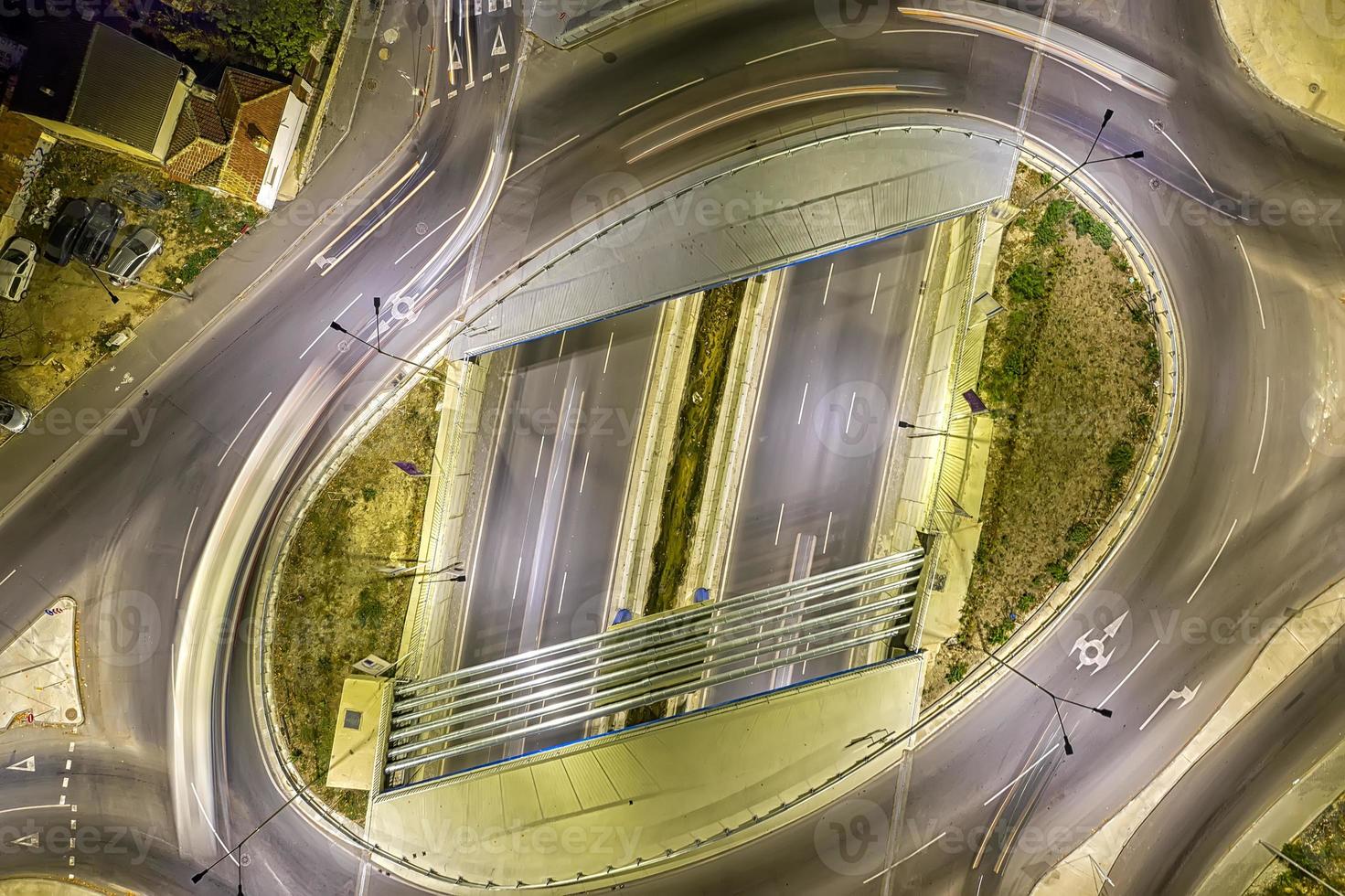 Circle junction traffic road with car light movement aerial view from a drone. photo