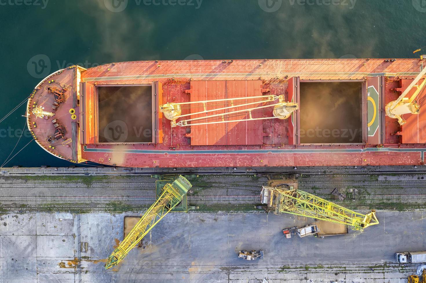 Top view from drone of a large ship loading grain for export. Water transport photo