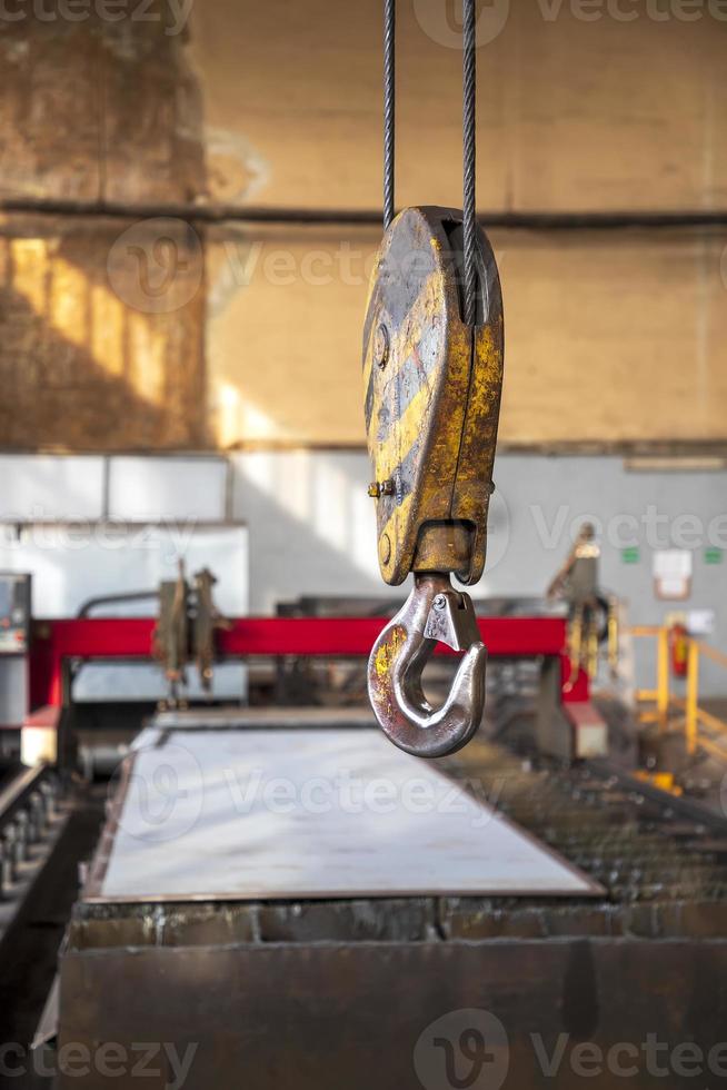 Crane clevis sling hook in an industrial factory. Vertical view. photo