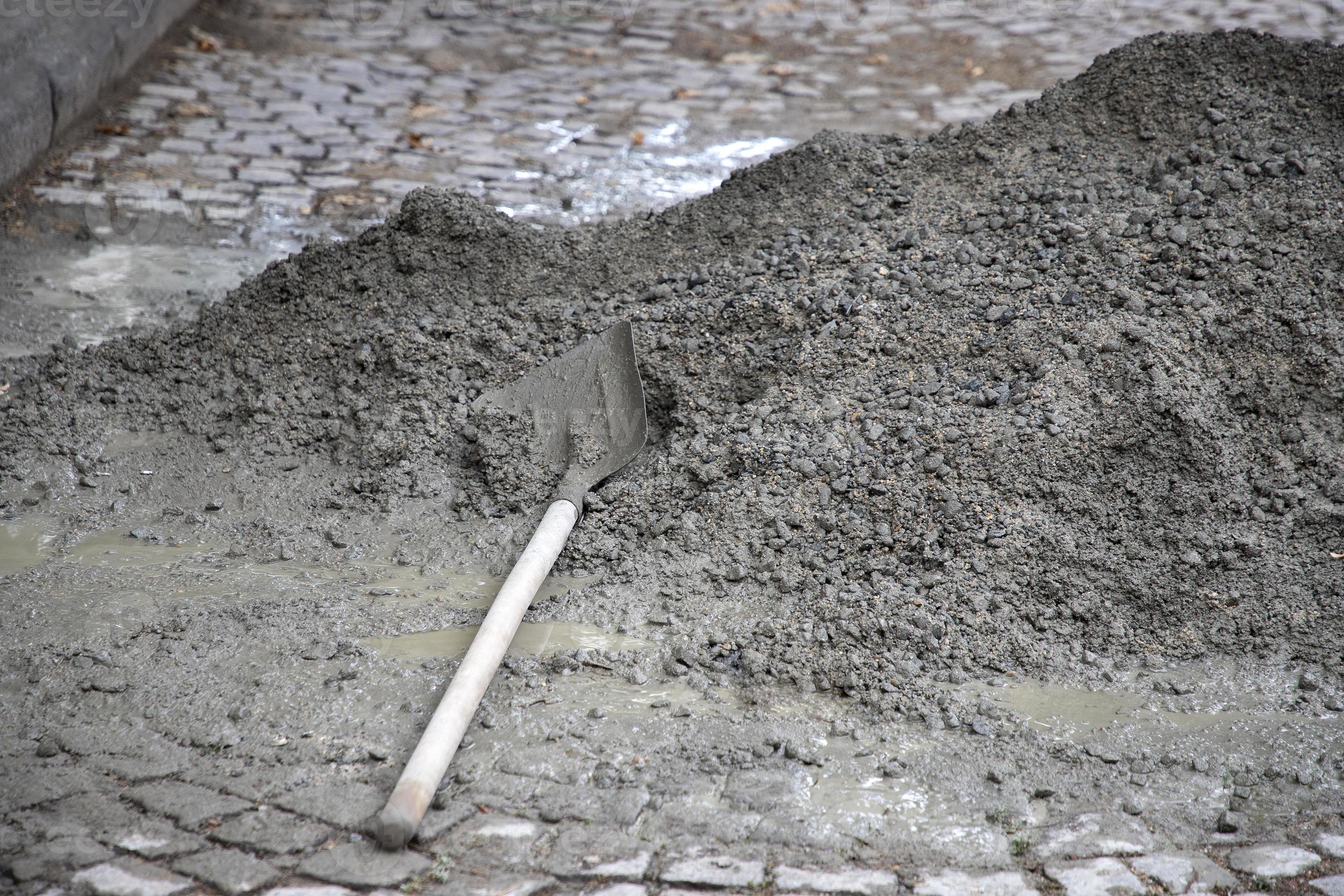 Hand mixing concrete mortar with shovel on construction site. 11807513