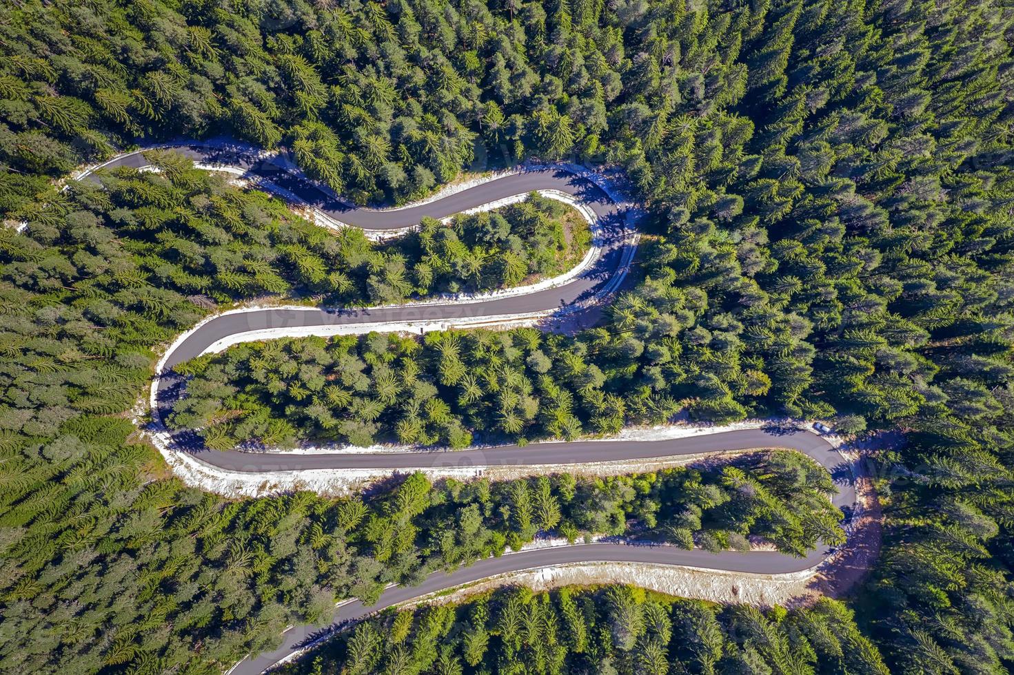 Aerial view from drone of curves of mountain road. Transportation and infrastructure concept photo
