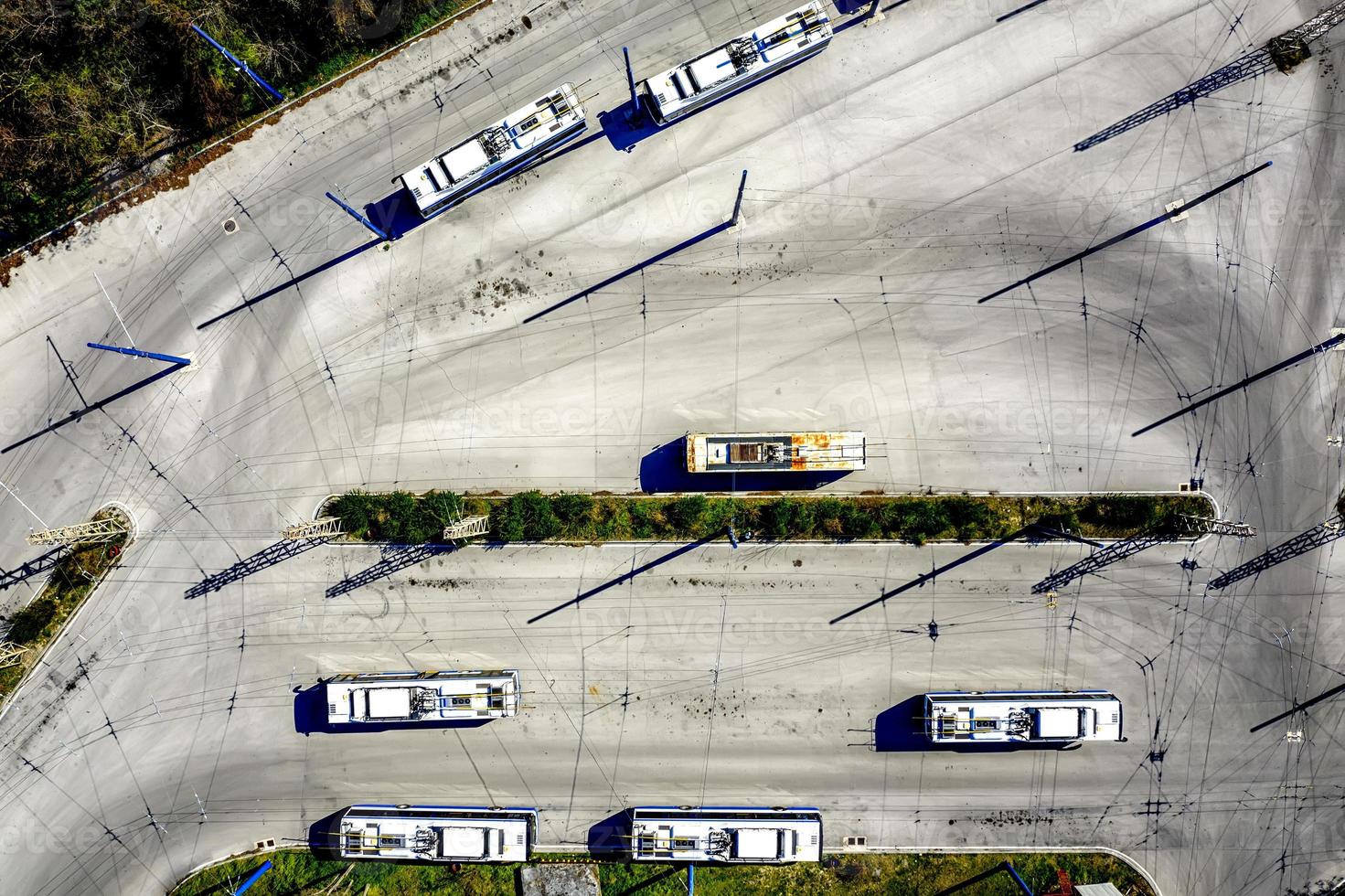 Aerial view from drone of bus at bus station with interesting shadows photo