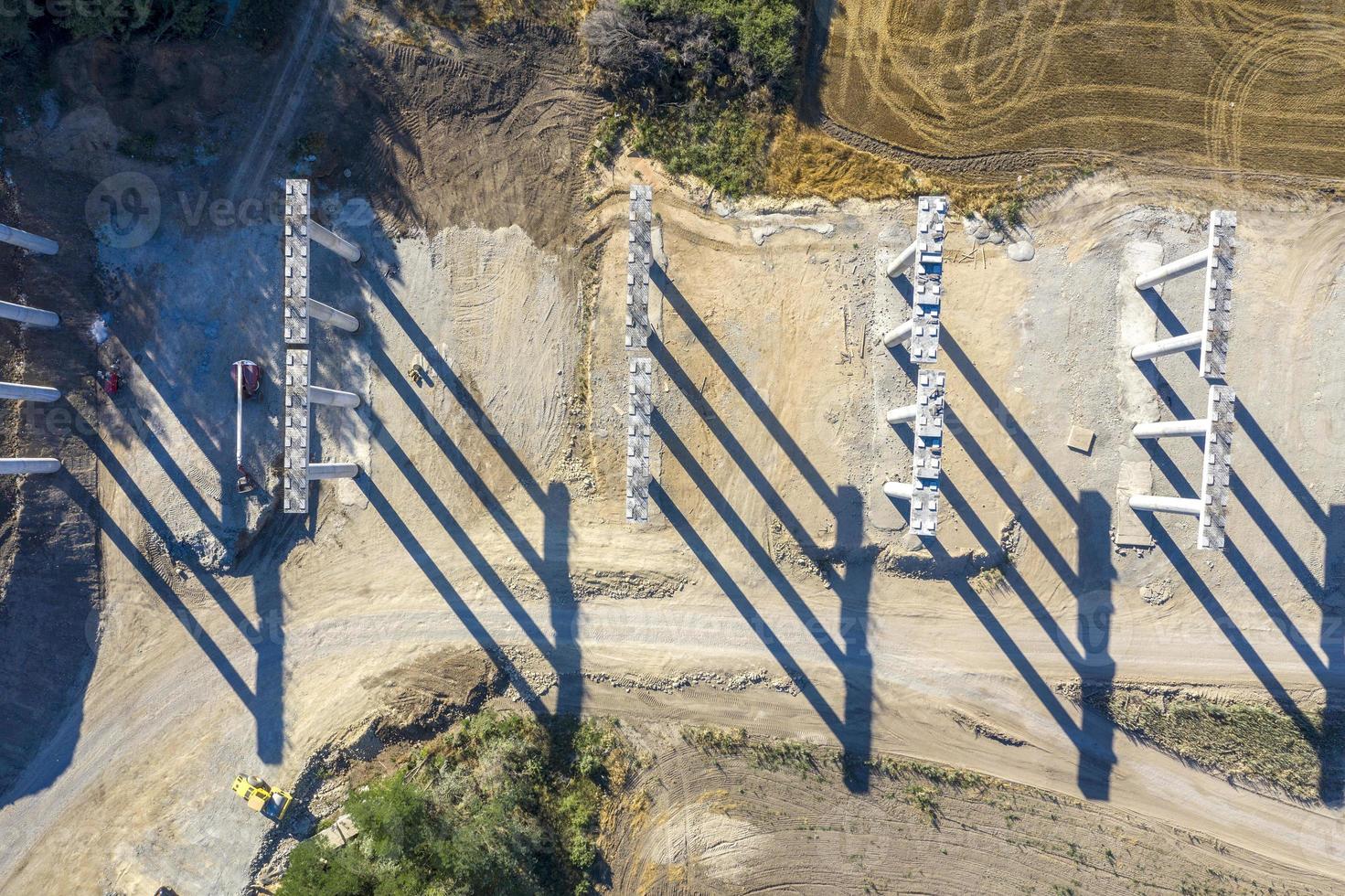 Abstract view with shadows of concrete new bridge supports. Construction of a road bridge. Top view photo