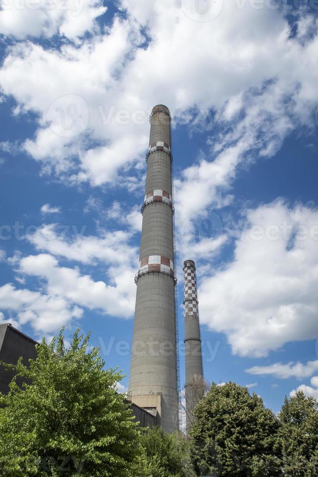 brick industrial chimney at the cloudy sky. Industry concept image. Old factory, ecology, industrial renewal, globalization. photo