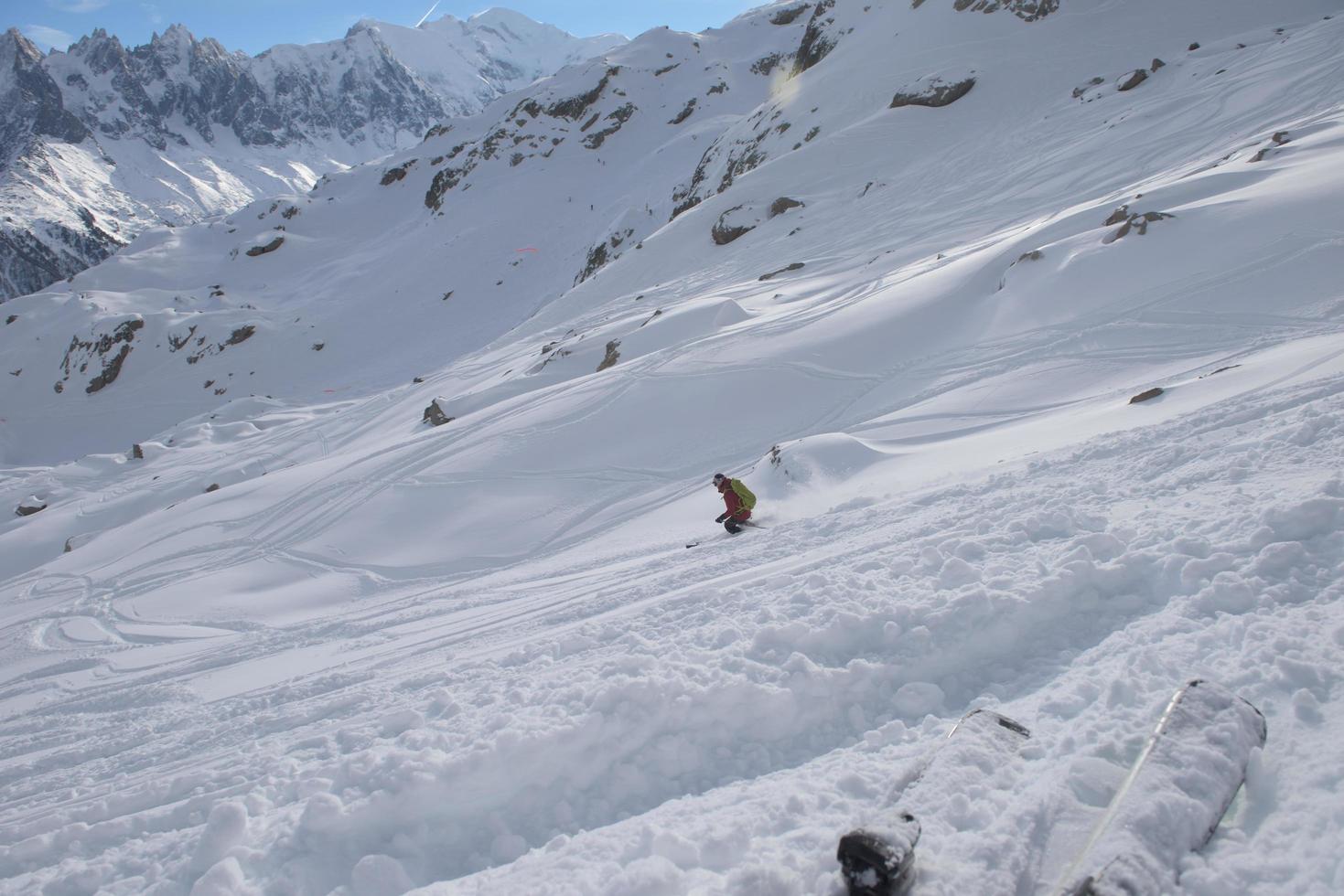 freeride skier skiing in deep powder snow photo