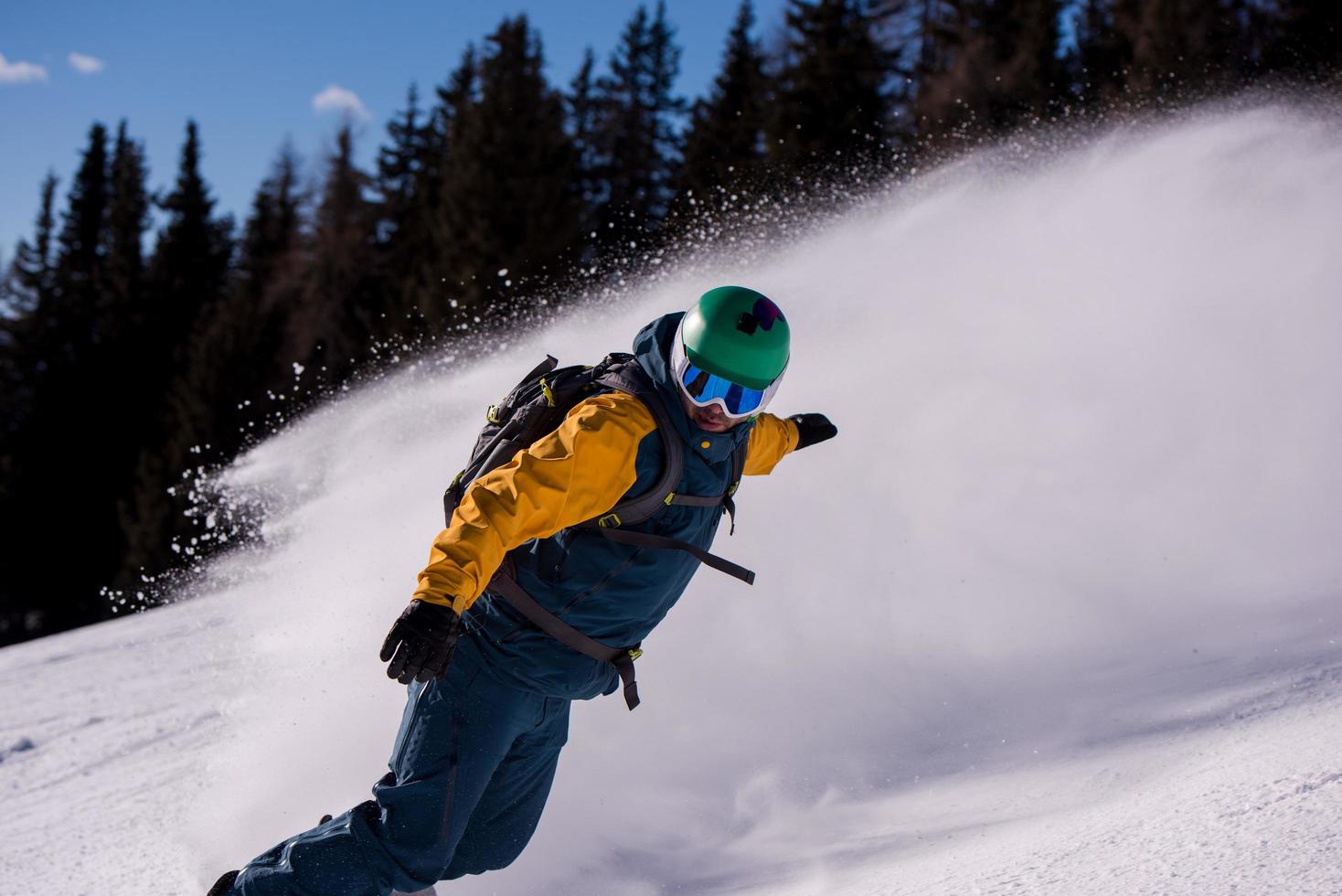 snowboarder running down the slope and ride free style photo