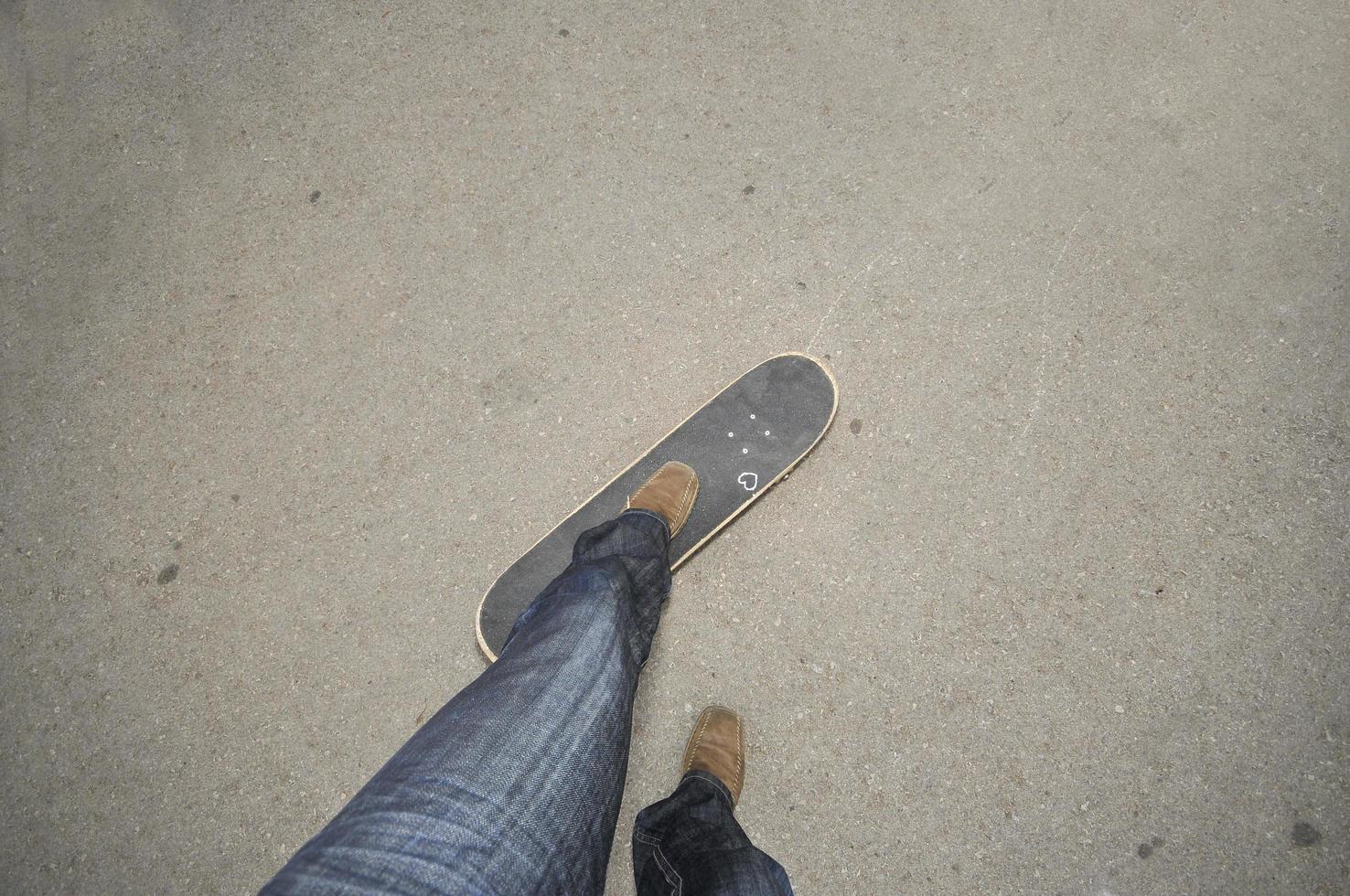 Foot standing on skate board photo