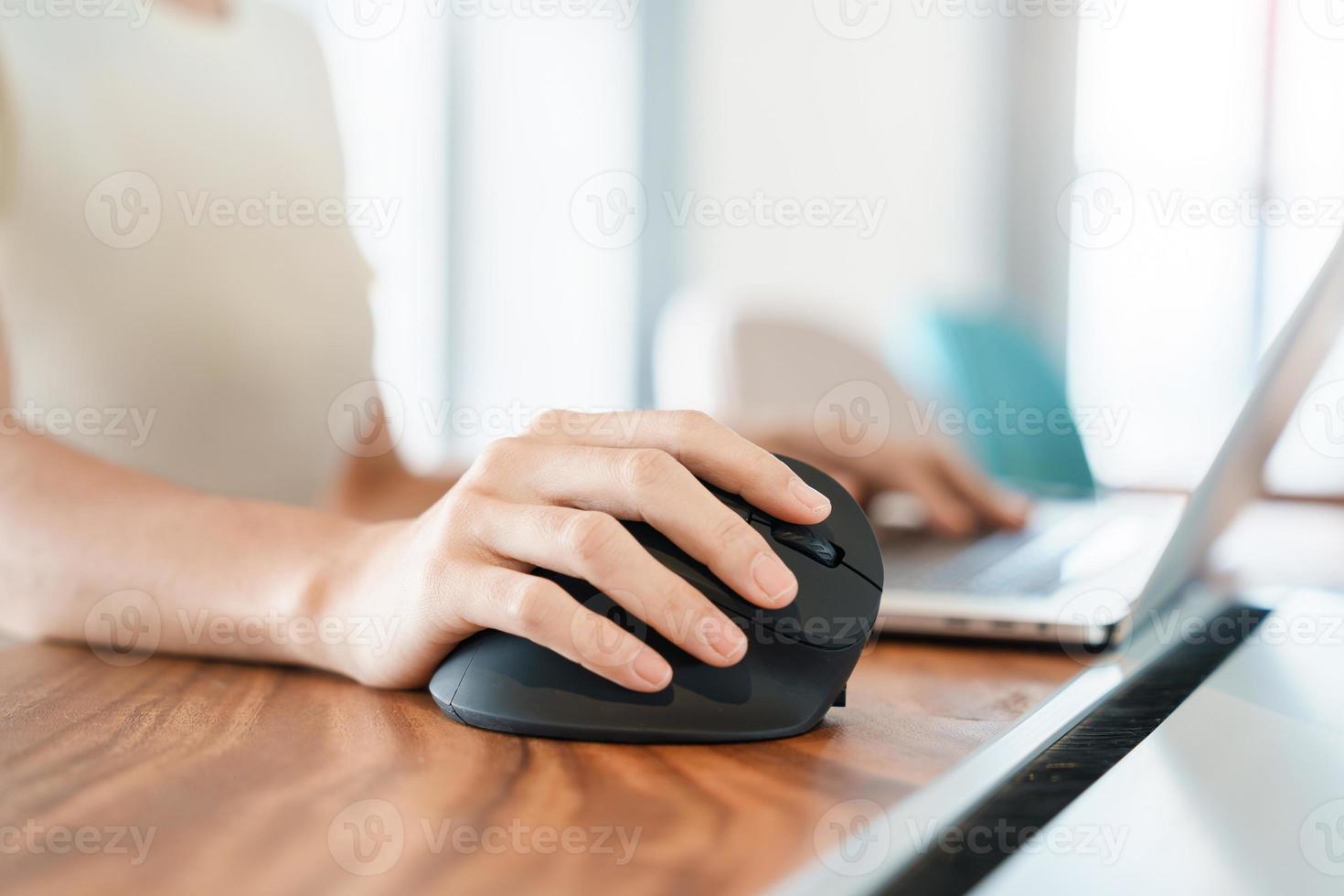 woman hand using computer ergonomic mouse, prevention wrist pain because working long time. De Quervain s tenosynovitis, Intersection Symptom, Carpal Tunnel Syndrome or Office syndrome concept photo