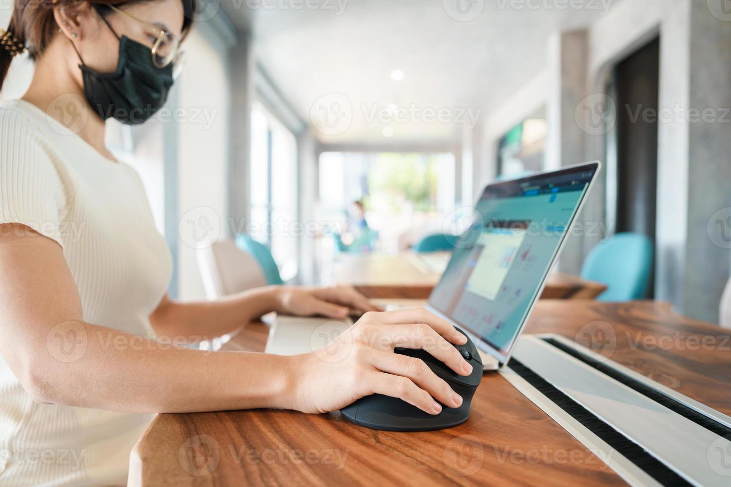 woman hand using computer ergonomic mouse, prevention wrist pain because working long time. De Quervain s tenosynovitis, Intersection Symptom, Carpal Tunnel Syndrome or Office syndrome concept photo