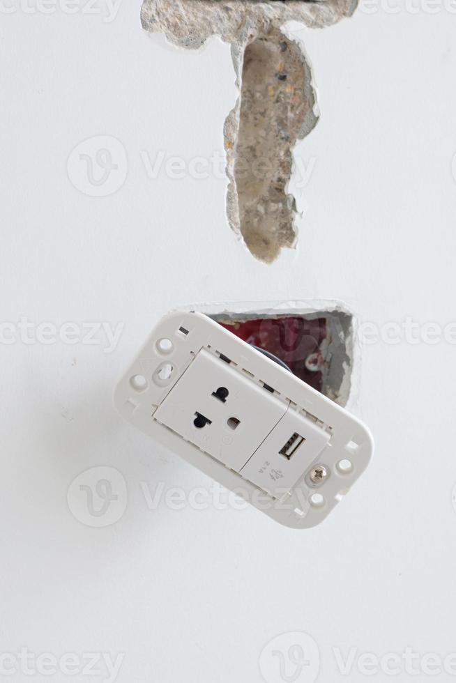 Electrical Wiring under plaster, hidden installation cables for socket to a concrete. Renovation, Repair and development of home and apartment concepts photo