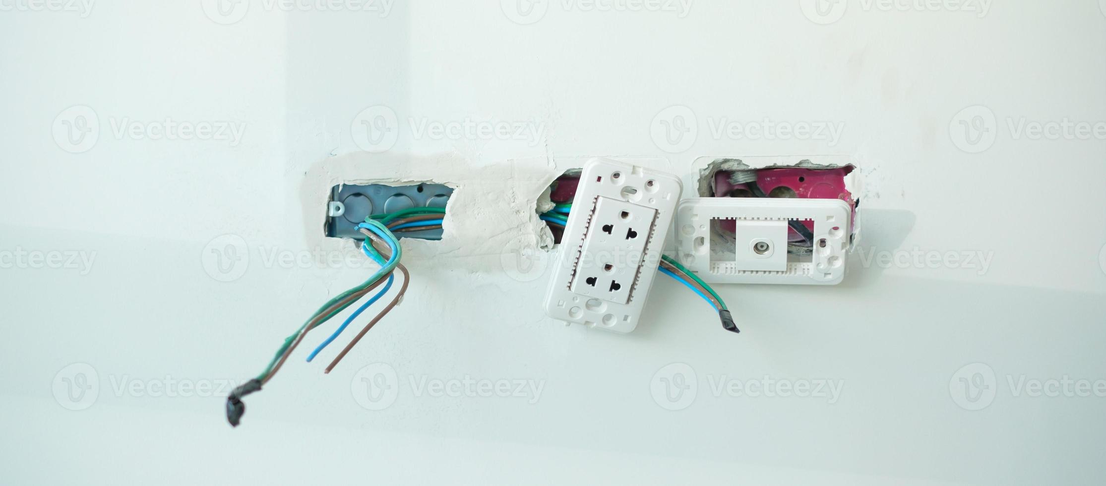 Electrical Wiring under plaster, hidden installation cables for socket to a concrete. Renovation, Repair and development of home and apartment concepts photo