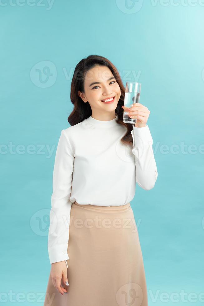 young woman drinks clean water adheres to drinking regime. photo