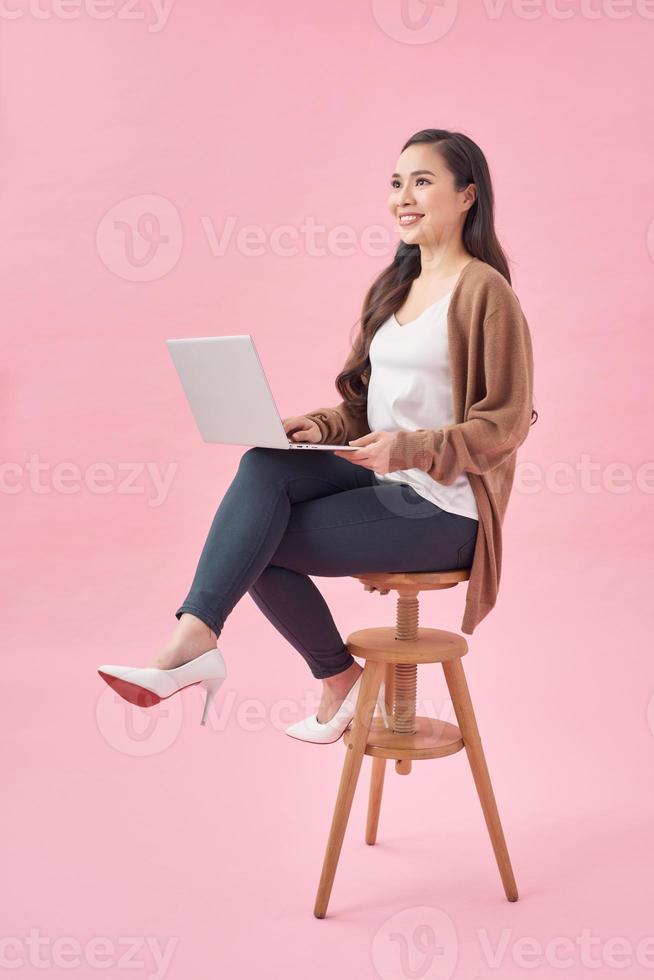 Girl is surfing through the Internet and looking for some interesting information. She is working on her laptop. photo