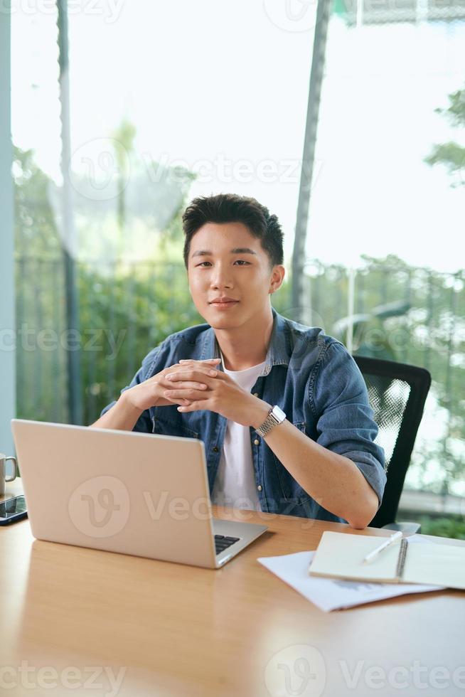 Man working with laptop in co working space. photo