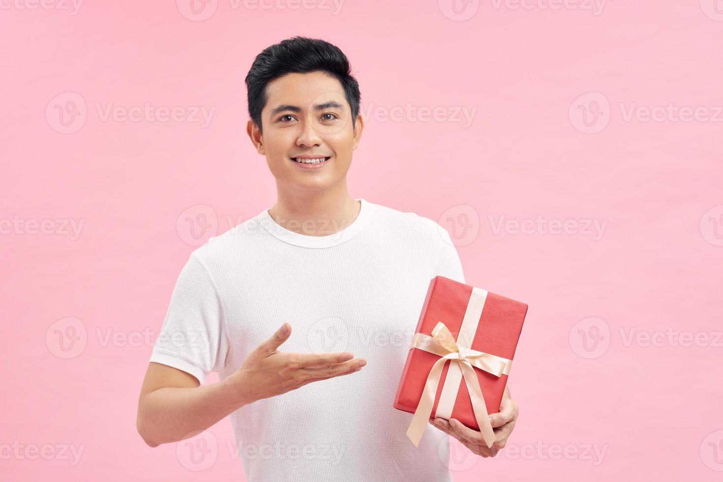 Man with white t-shirt holding gift boxes in hands photo