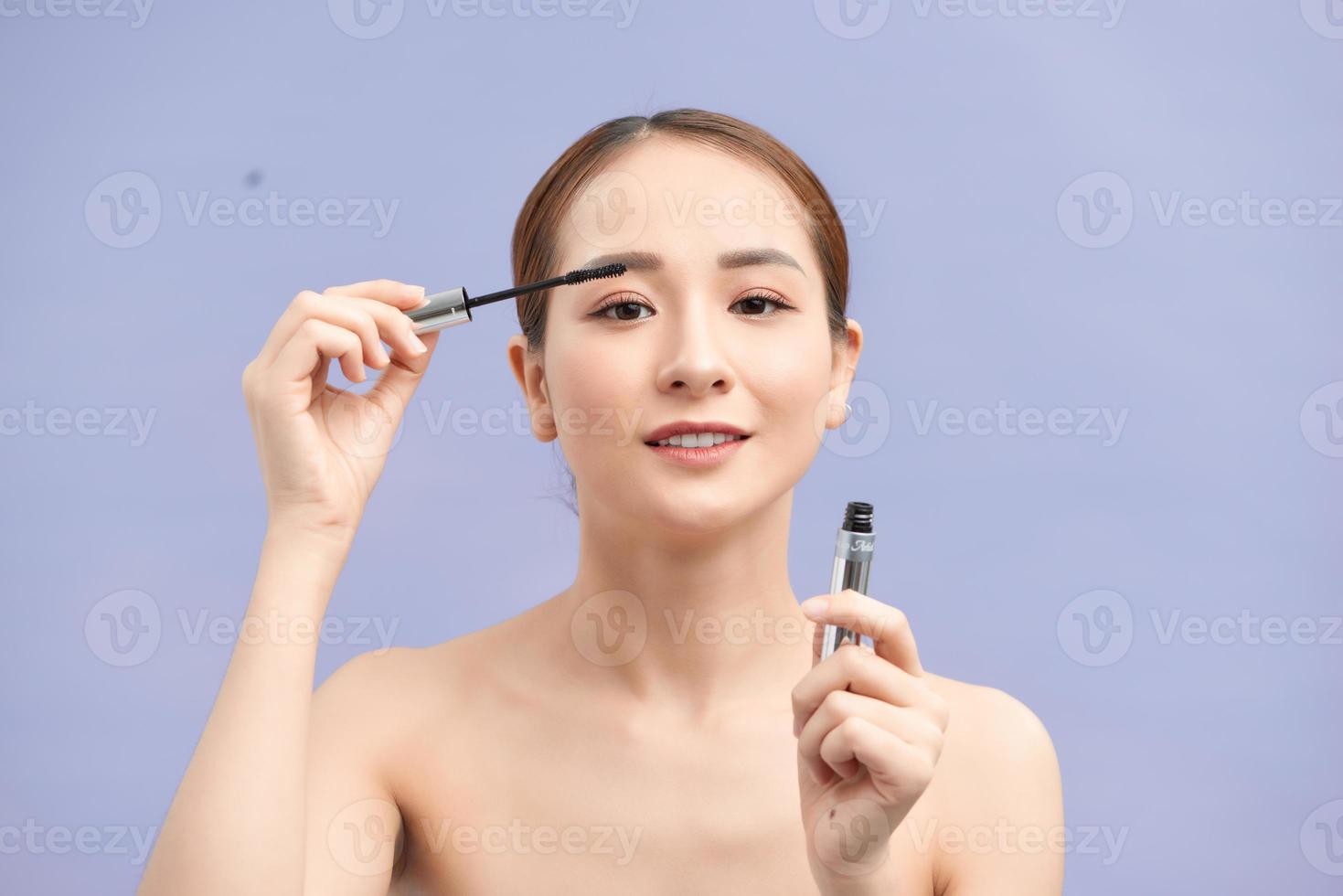beautiful young woman applied mascara, studio beauty portrait photo