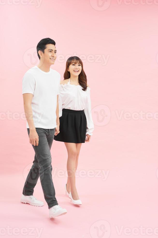 Full length body size photo of couple walking streets of town they have just arrived in while isolated with pastel background
