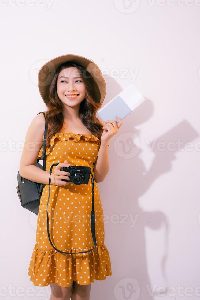 Beautiful travel woman with passport isolated on pastel backgroun photo