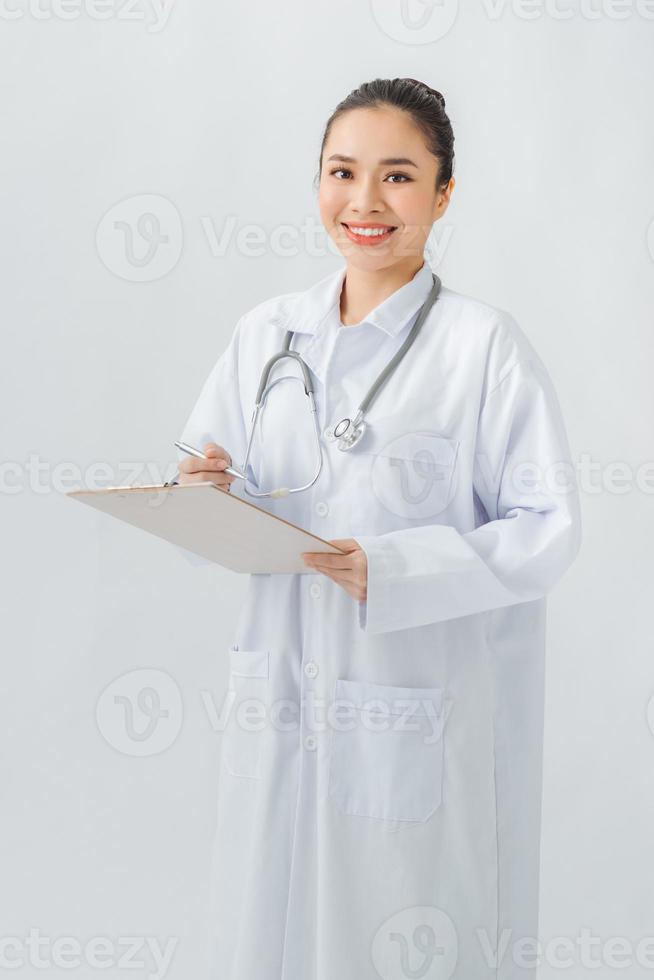 Doctor with a stethoscope, holding a notebook in his hand. photo