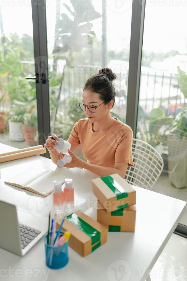 Woman online store preparing a parcel at workplace. photo