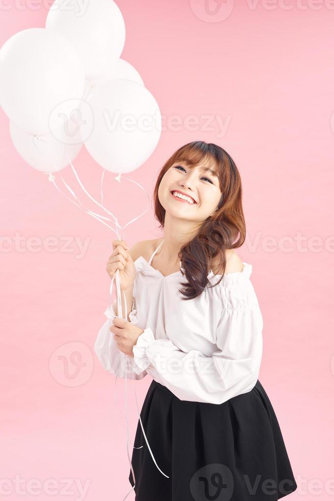 Graceful slim birthday girl posing with balloons photo