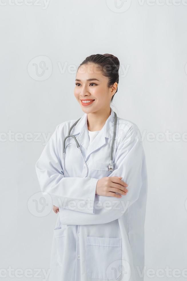Confident young woman doctor  standing arms crossed photo