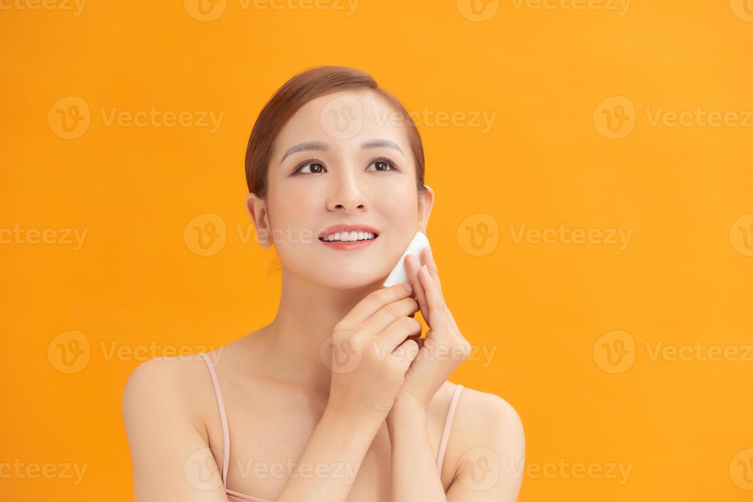 woman with a sponge wihte background cotton pad problem skin photo