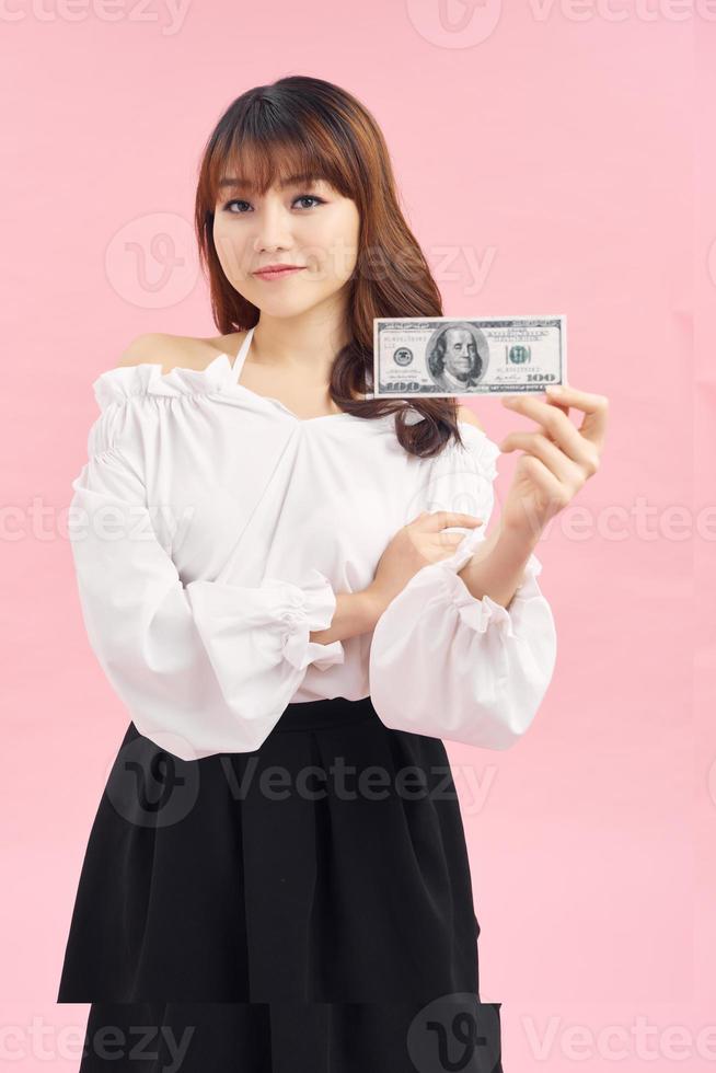 pretty smiling girl looking at camera and holding money isolated on white photo
