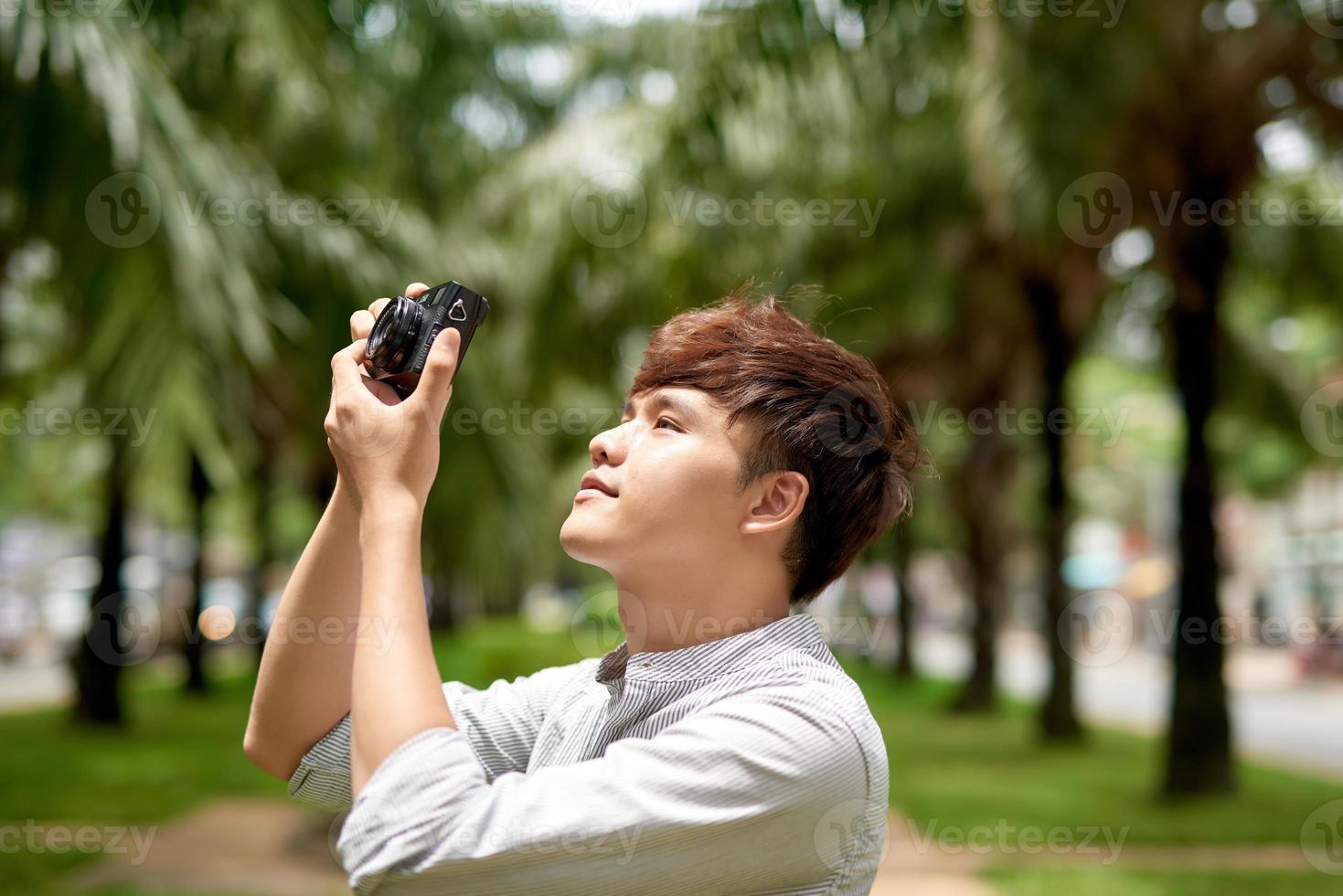 Young hipster photographer with retro film photo camera