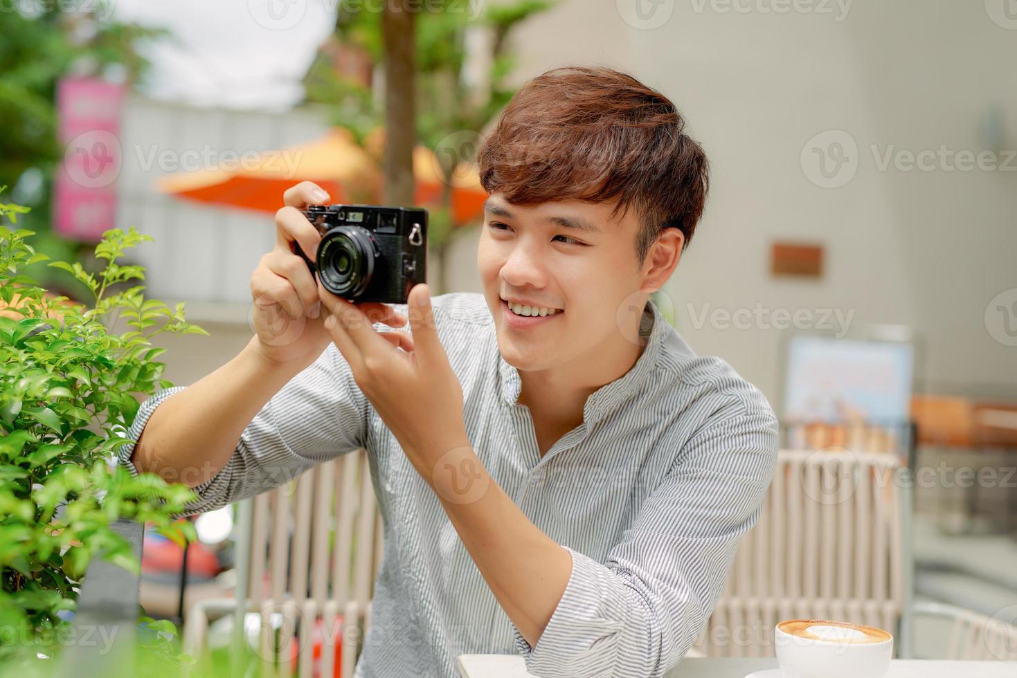 Male photographer taking picture in coffee shop photo