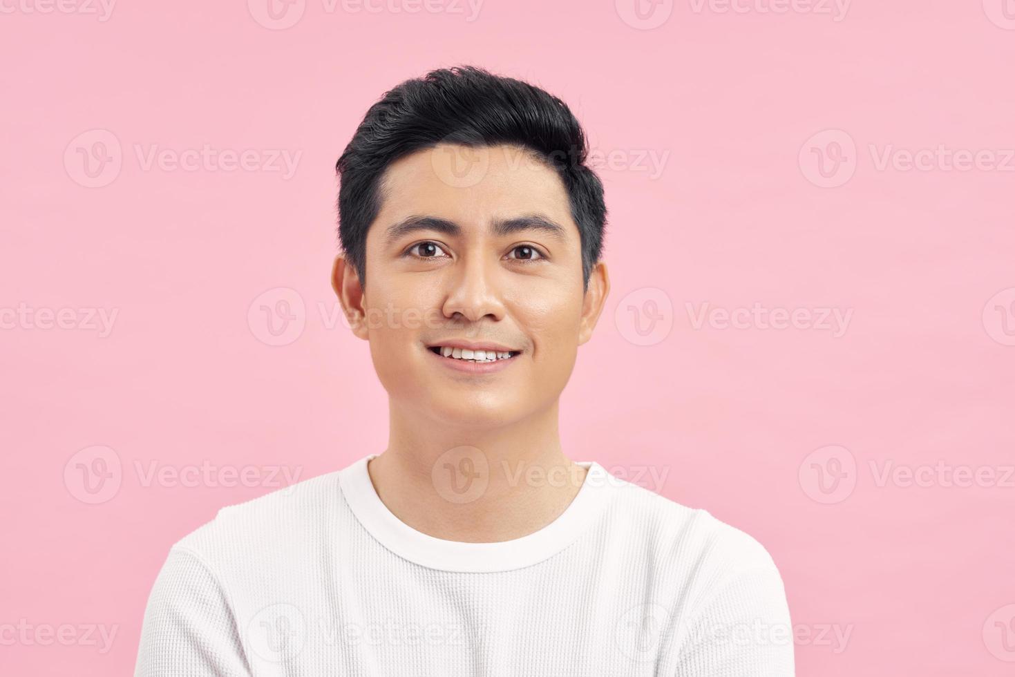 Young Asian man close up shot isolated on pink photo