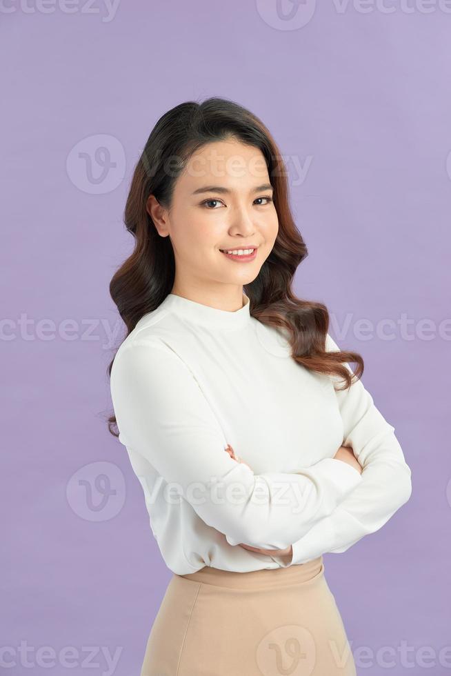 Very happy young woman standing with arms crossed photo