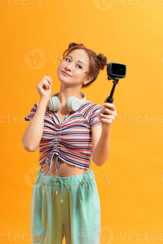 Happy Asian woman using action camera selfie herself photo