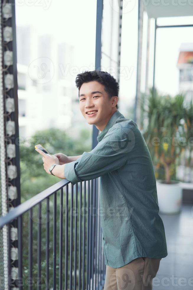 View of a Young attractive business man using smartphone photo