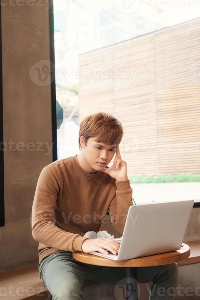 serious writer making notes about new idea working in coffee shop photo