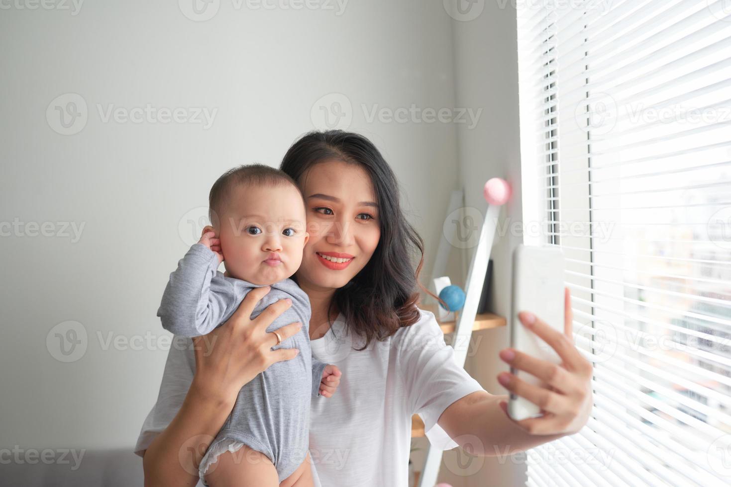 Woman with a baby doing a selfie photo